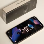 Close-up of Google Pixel 9 smartphone with the original packaging box, showcasing sleek design.
